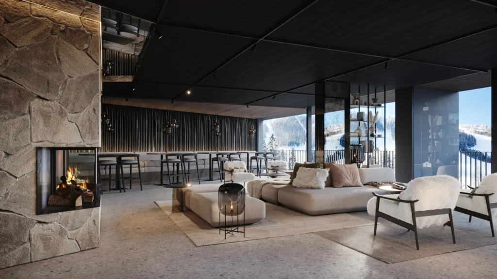 Spacious mountain hotel lounge with fireplace, natural materials, and comfortable seating for guests.